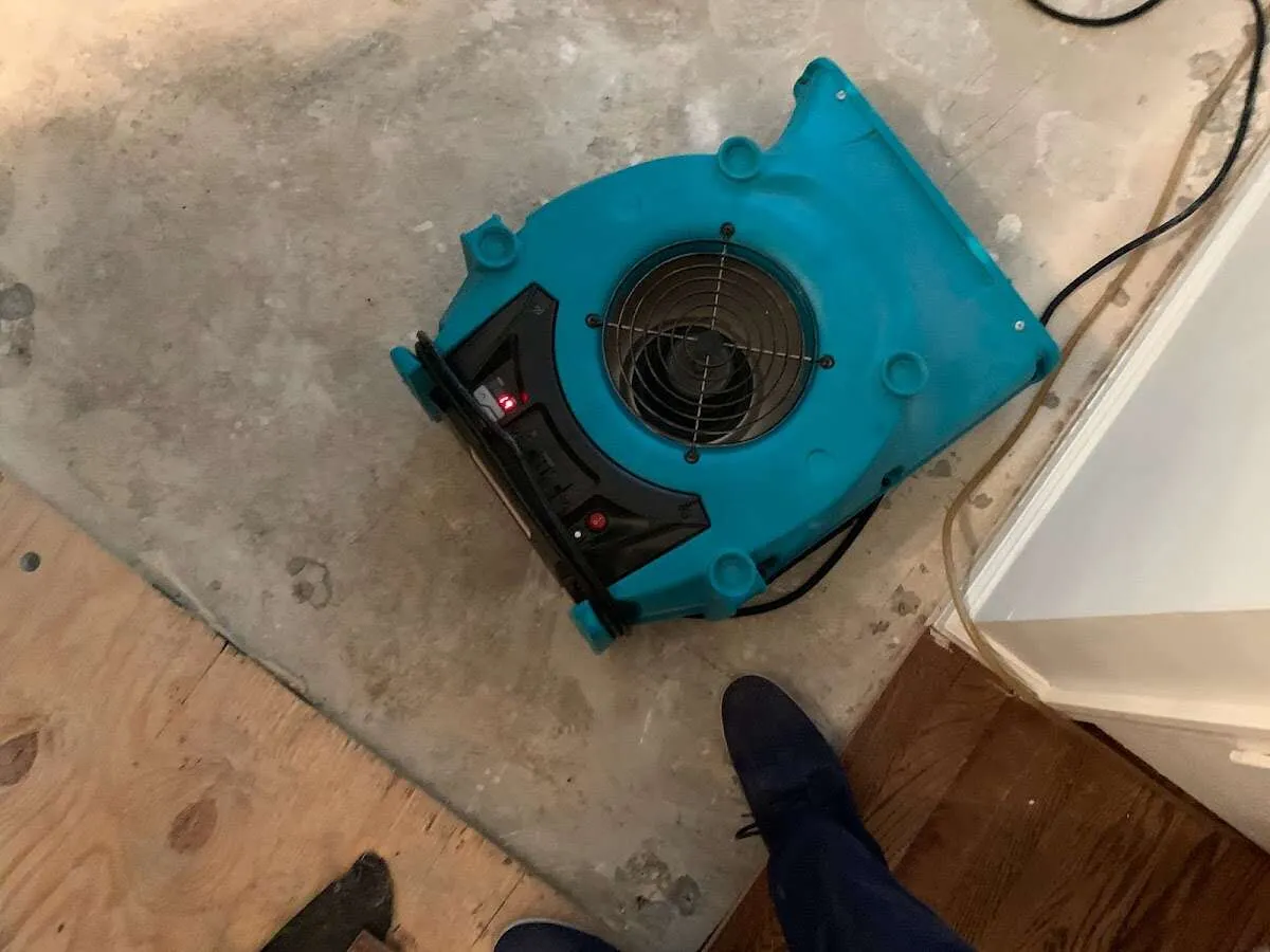 Air mover drying subfloor during Commercial Water Damage Restoration in Killingworth